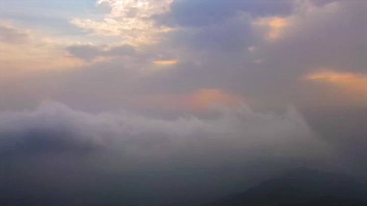 Fog covers the Black Mountains in Jazan at sunset, aerial shot.