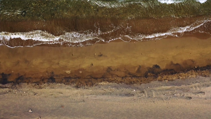 Al-Qahma Black Beach in Jazan from above, an aerial shot.