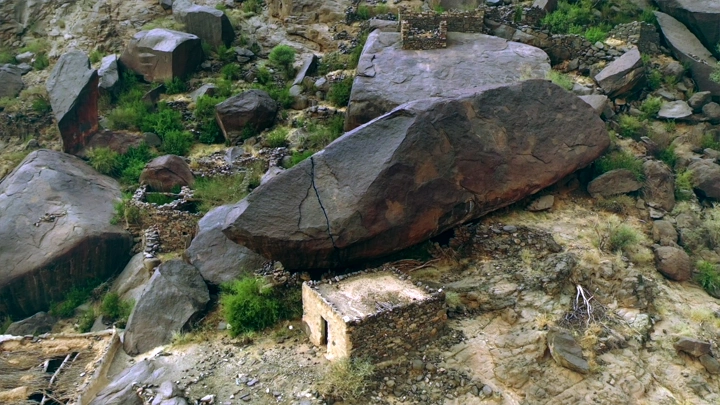 Stone houses in Ghey village, Asir among large rocks, aerial shot.