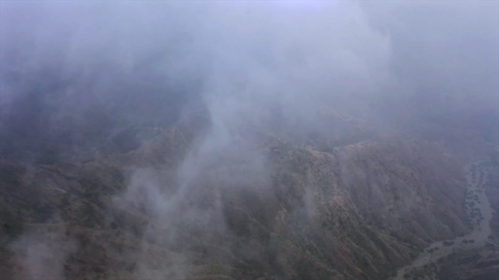 Mountains of Talan covered in fog in Jazan, aerial shot.
