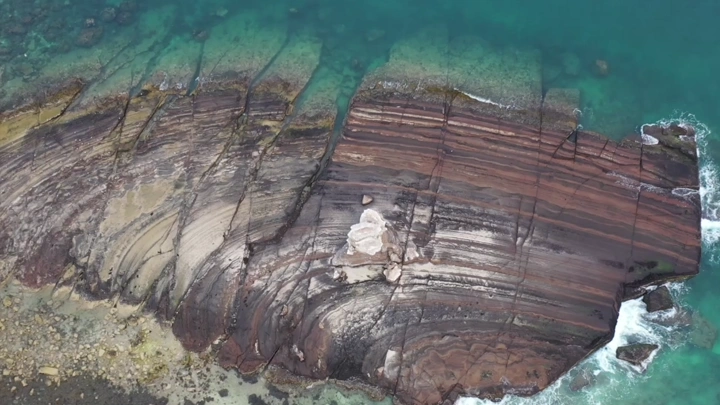 تكوين صخري على جزيرة الميفا بجوار جزيرة جبل كدمبل في البحر الأحمر بمنطقة عسير، لقطة جوية اسقاطية.