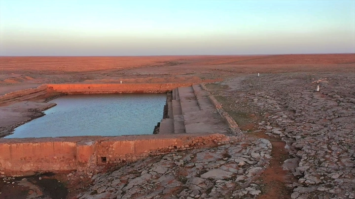 بركة في الصحراء عند الغروب، لقطة جوية.
