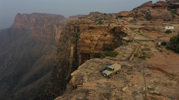 سيارة على حافة جبال القهر في جيزان، لقطة جوية.