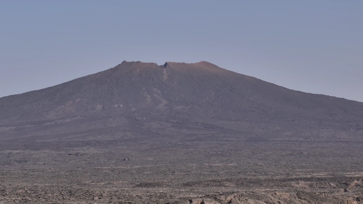 جبل بركاني في جبال القدر تحت سماء صافية، لقطة جوية .