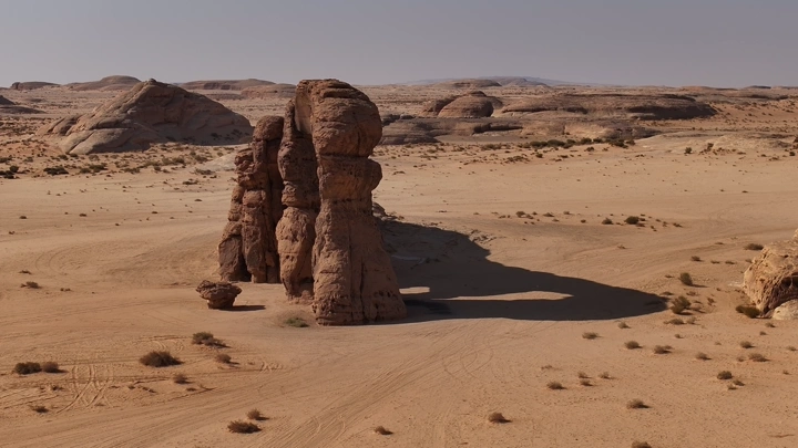Rock formation in a vast desert, aerial shot.