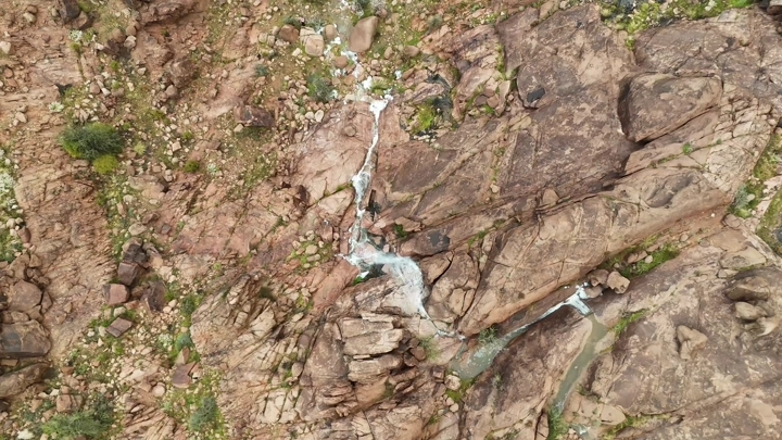 Al-Ra'ila Waterfalls during the rain, rocky in Hail during the rain, aerial shot.