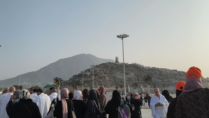 Visitors on Mount Arafat in Mecca on a sunny day, ground shot.