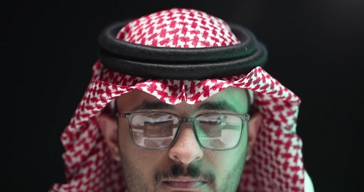 رجل سعودي يرتدي نظارات يعمل، لقطة امامية.