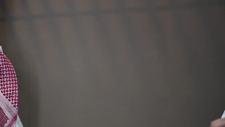 مصافحة بين شخصين بملابس تقليدية، لقطة مقربة.