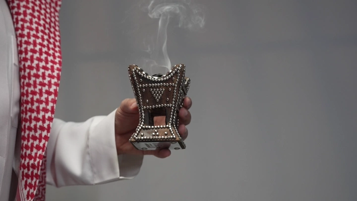 رجل سعودي يحمل مبخرة تقليدية، لقطة قريبة.