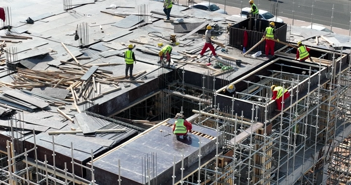 Construction workers at a building site, overhead shot.