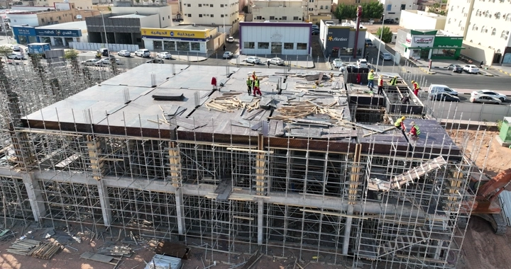 Construction workers at a building site in the city, aerial shot.