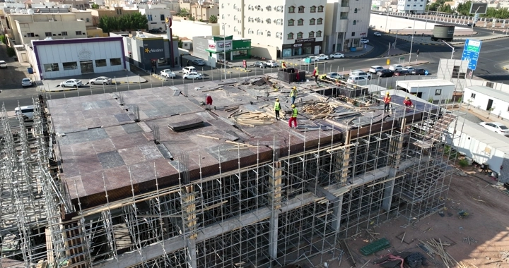 Construction workers at a building site in the city, aerial shot.