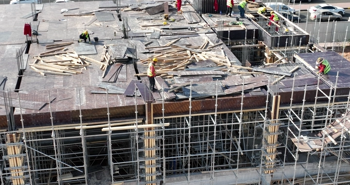 Construction workers on a building site, aerial shot.