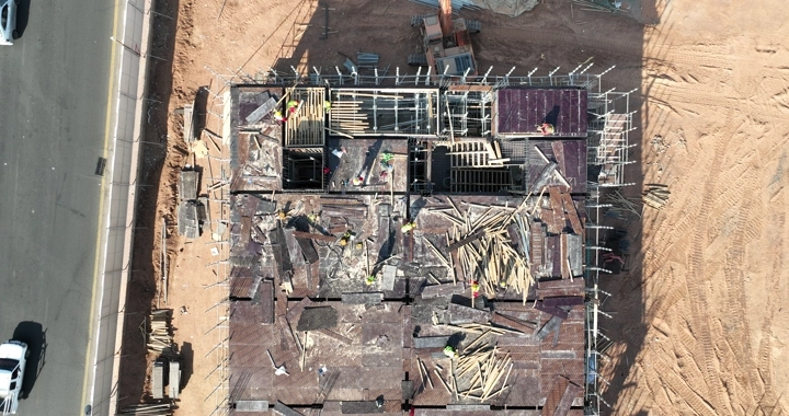 Construction workers at a building site, aerial shot.
