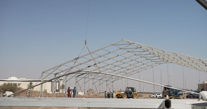 Metal structure at construction site under clear sky, daytime shot.