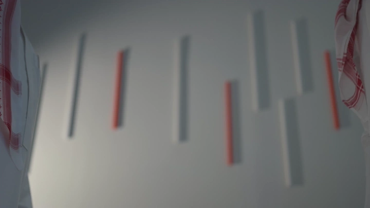 Handshake between two people in a modern room, close-up shot.