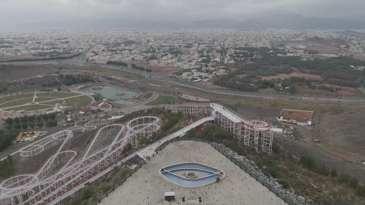 Amusement park and mountains in Hail, aerial shot.