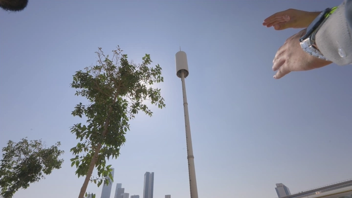 Communication tower in a modern city, low-angle shot.