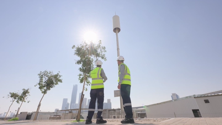 Engineers in reflective vests at a construction site, daytime shot.