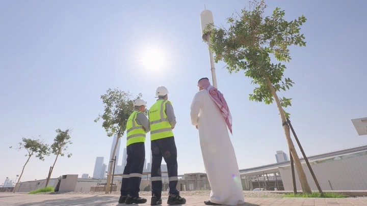 Engineers inspecting a construction site on a sunny day, wide shot.