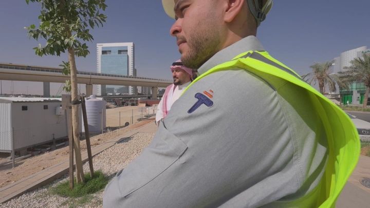 Engineers at a construction site in a modern city, daytime shot.