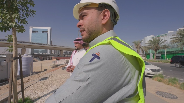 Engineers at a construction site in a modern city, daytime shot.