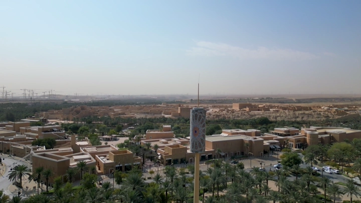 مشهد جوي لمدينة الدرعية في الرياض، يظهر المباني التقليدية والنخيل.