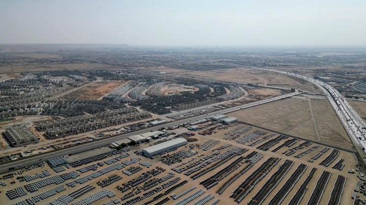 مستودع سيارات ضخم في منطقة صحراوية، لقطة جوية.