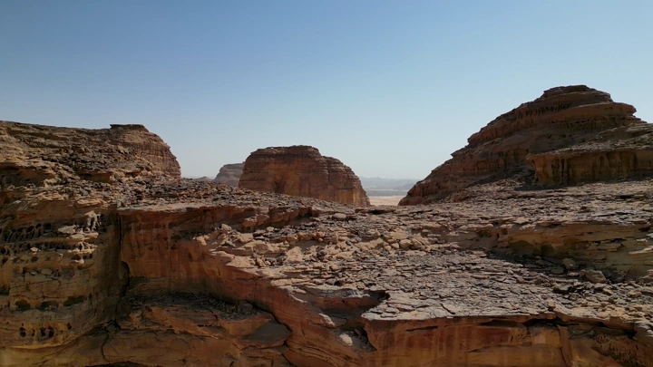 تكوينات صخرية في العلا تحت السماء الزرقاء، لقطة درون.