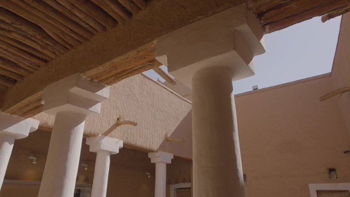 أعمدة قصر المصمك في الرياض تحت السماء الصافية، لقطة من الأسفل.