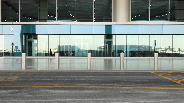 واجهة مطار حديثة مع زجاج عاكس ووقوف سيارة، لقطة أمامية.