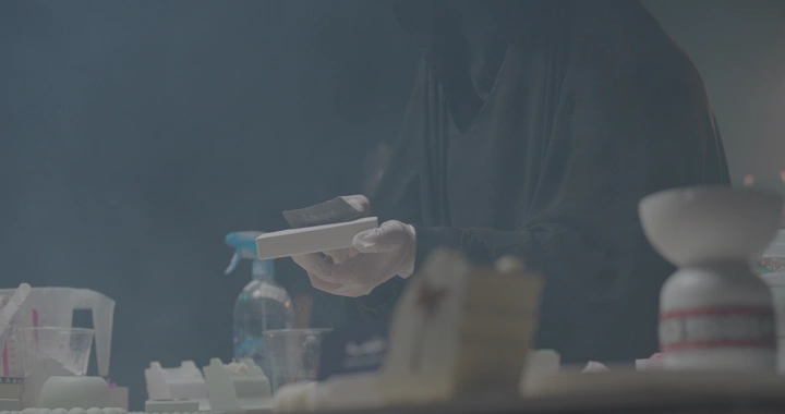 شخص يصنفر قطعة جبس في ورشة، لقطة مقربة.