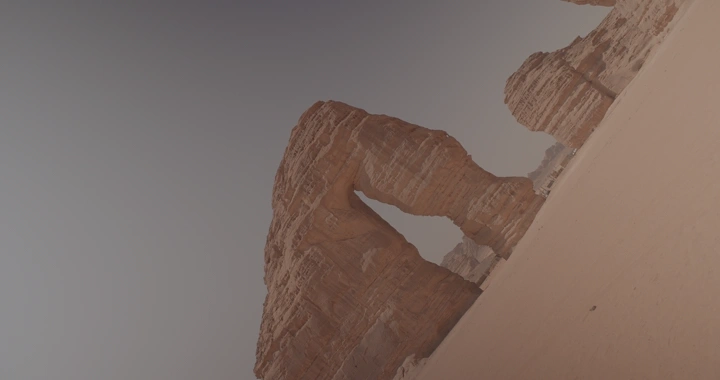 رجل يقف امام جبل الفيل في العلا تحت سماء صافية، لقطة مائلة.