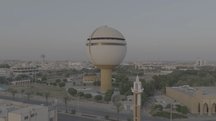 برج مياه بريدة في القصيم، لقطة جوية في النهار تظهر المدينة.