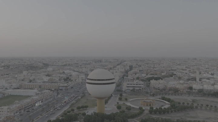 برج مياه بريدة في القصيم عند الغروب، لقطة جوية واسعة.