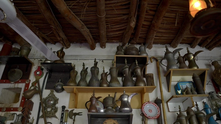 مجموعة من الدلال والتحف في متحف تراثي، لقطة داخلية.