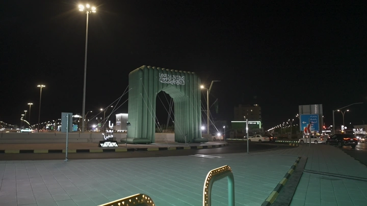 بوابة مضاءة في حائل ليلاً على هوية اليوم الوطني، تصوير ليلي.