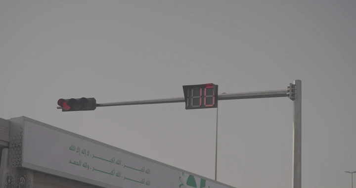 إشارة مرور مع عداد تنازلي في يوم غائم، لقطة قريبة.