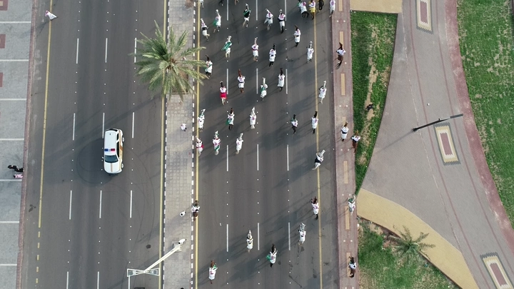 A parade on a street during National Day in Hail, aerial shot.
