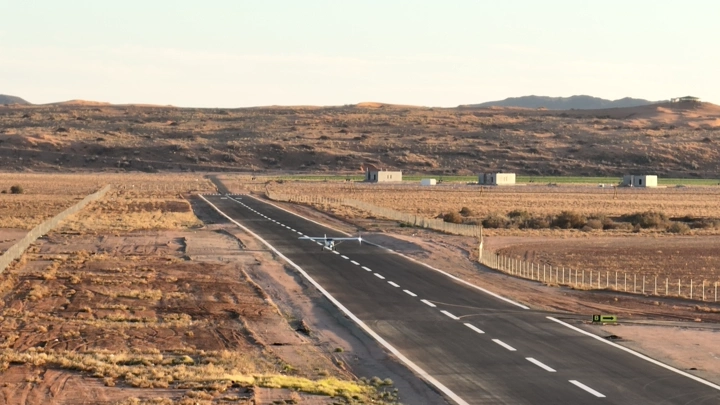 طائرة صغيرة تقلع من مدرج طائرات في منطقة صحراوية، لقطة جوية.