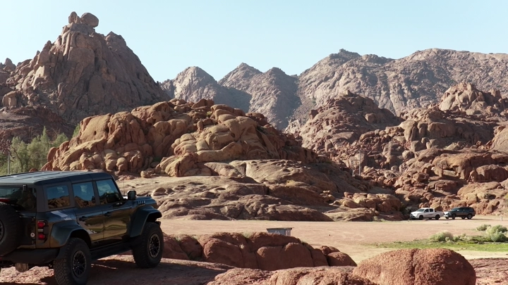 SUV on a mountainous edge in Hail, daytime shot.