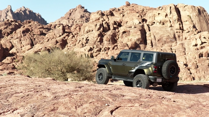 SUV on a rocky edge in Hail, daytime shot.
