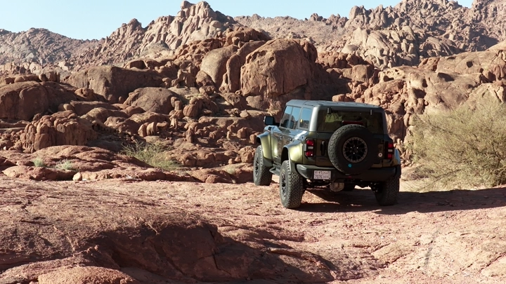 SUV on rocky terrain, rear shot.