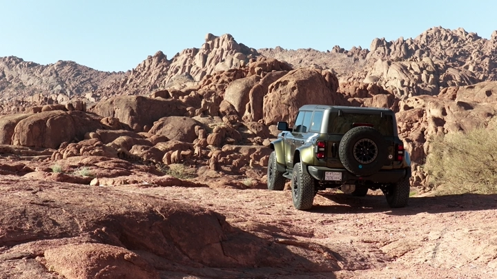 SUV on rocky terrain in Hail, daytime shot.