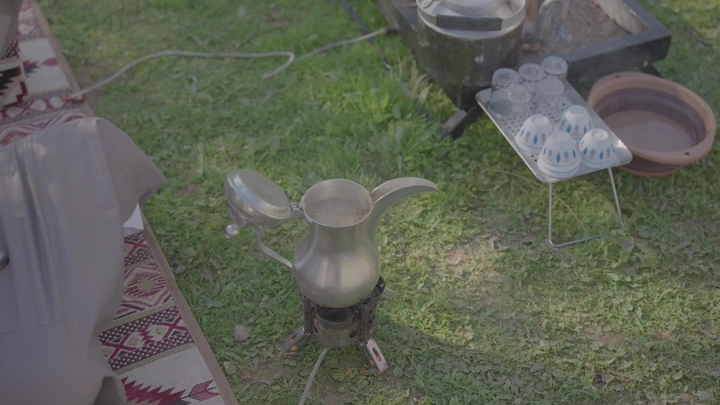 دلة قهوة سعودية على موقد في الهواء الطلق، لقطة علوية.