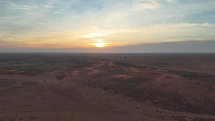صحراء واسعة عند شروق الشمس، لقطة جوية.