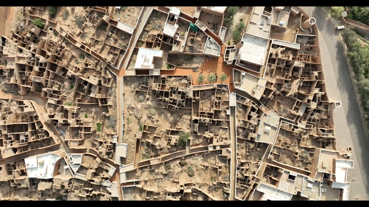 صورة جوية لمدينة قديمة في محافظة شقراء، تُظهر المباني الطينية والشوارع الضيقة.