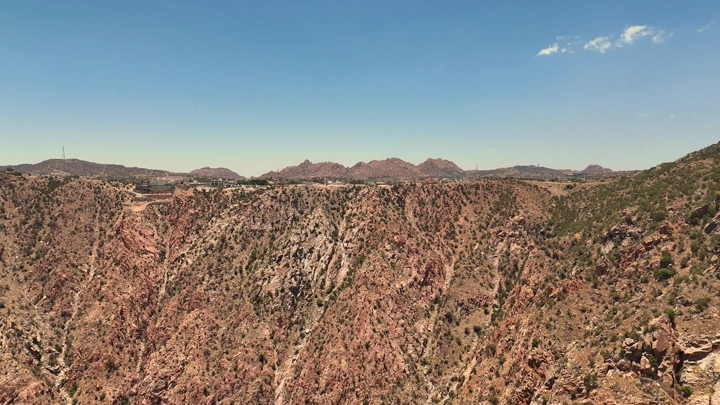 جبال ومدينة الطائف تحت سماء زرقاء صافية، تصوير جوي.